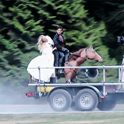 Jennifer and Colin riding the fake horse on set