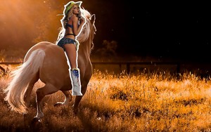 hot cowgirl riding her beautiful palomino horse