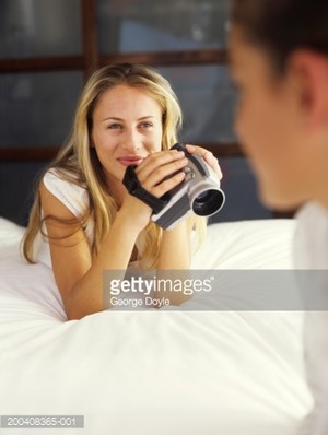 Smiling girl with camcorder