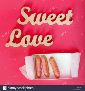  words sweet l’amour wooden letters on rose paper with open box of fresh HAJDDR
