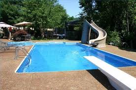Pool With A Diving Board And Water Slide