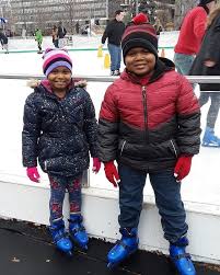 Children Ice Skating In Public Square
