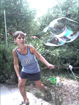 Nikita 'Xlson137' plays with soap bubbles in the garden