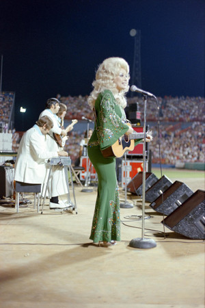 Dolly Parton performing at WBAP's Country Gold 4th anniversary event Arlington Stadium | 1974