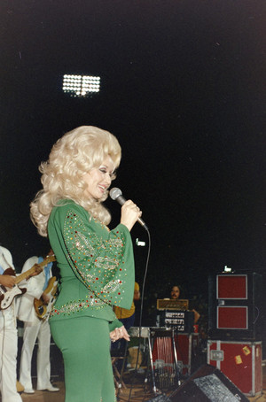 Dolly Parton performing at WBAP's Country Gold 4th anniversary event Arlington Stadium | 1974