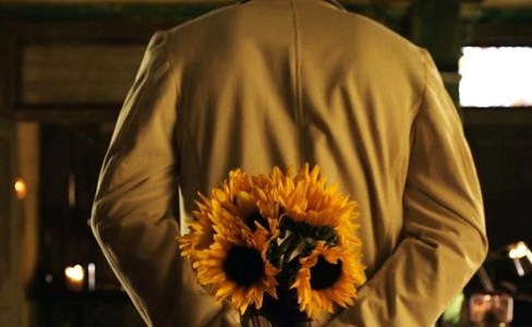  Who is the guy holding the sunflowers?