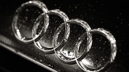 What does the Audi four-ring logo symbolize?