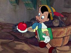  Who did Pinocchio encounter first while he was on his way to school?