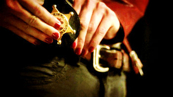 In 1x05 “That Still Small Voices”, what happens when Emma puts on her deputy badge for the first time?