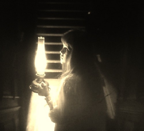  Mary walking down a dark staircase at night