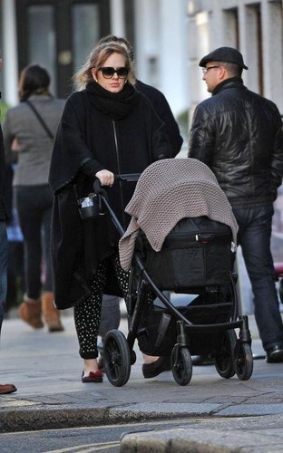 Adele walking with his son through the streets of London