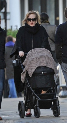 Adele walking with his son through the streets of London