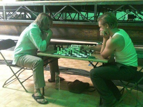  Josh Hutcherson and Woody Harrelson playing chess on set