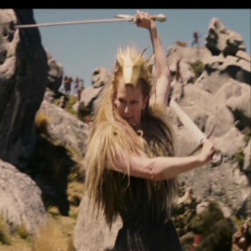  Jadis waits for Peter to get up after she had knocked him down.