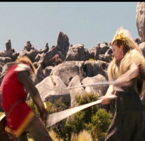  Jadis swings her sword at Peter.