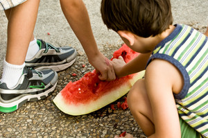 Some kids eating a watermelon