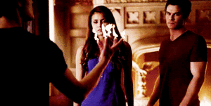  Damon stepping protectively in front of Elena.