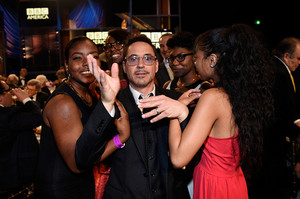 Robert Downey Jr. looking happy and cute with an assortment of people at the 2014 Britannia Awards 