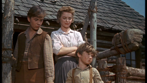  Tommy Kirk as Travis and Dorothy McGuire as Katie, and Kevin Corcoran as Arliss Coates in Old Yeller