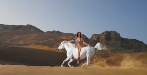 a native american woman riding on her beautiful white steed