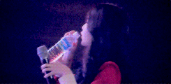  IU gracefully drinking her water and giving it to a peminat afterwards