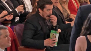  Christian Bale enjoying some Girl Scout biscotti, cookie at the Oscars 2016