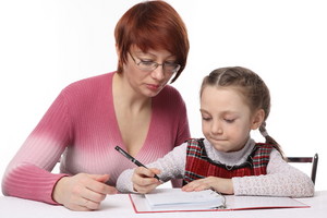 Mother giving child writing tips