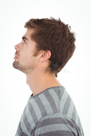  side view serious man looking up against white background 60556668