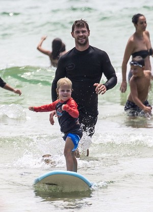  Chris teaching one of his sons how to surf