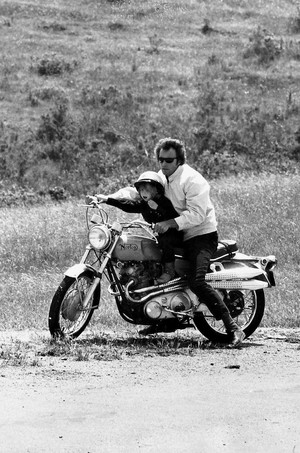  Clint Eastwood takes his son Kyle for a spin on his motorcycle 1973