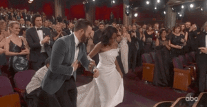  Chris Evans helps Regina King up the stairs to the stage after her Oscars win
