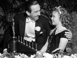 Walt Disney Receiving An Oscar From Shirley Temple