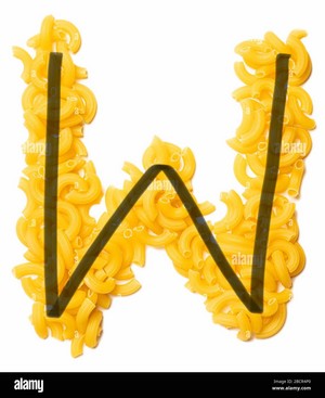 Letter W of the English alphabet from dry pasta on a white