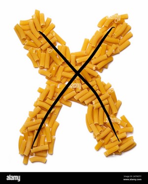  Letter X of the English alphabet from dry pastas, pasta on a white